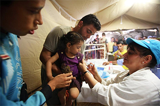 Nursing station UNICEF - Child gets a vaccine from a doctor